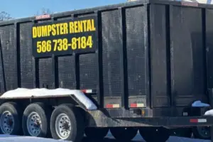 20‑yard rubber‑wheeled dumpster trailer from United Rent a Dumpster at a residential project in Metro Detroit